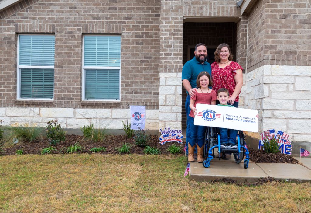 Veteran family in front of new home